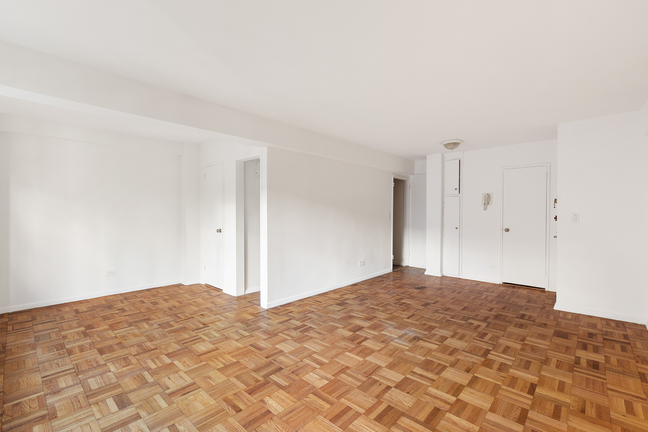335 East 51st Street, Unit 6G Manhattan, NY 10022 - Photo 4 of 12 a view of empty room with wooden floor