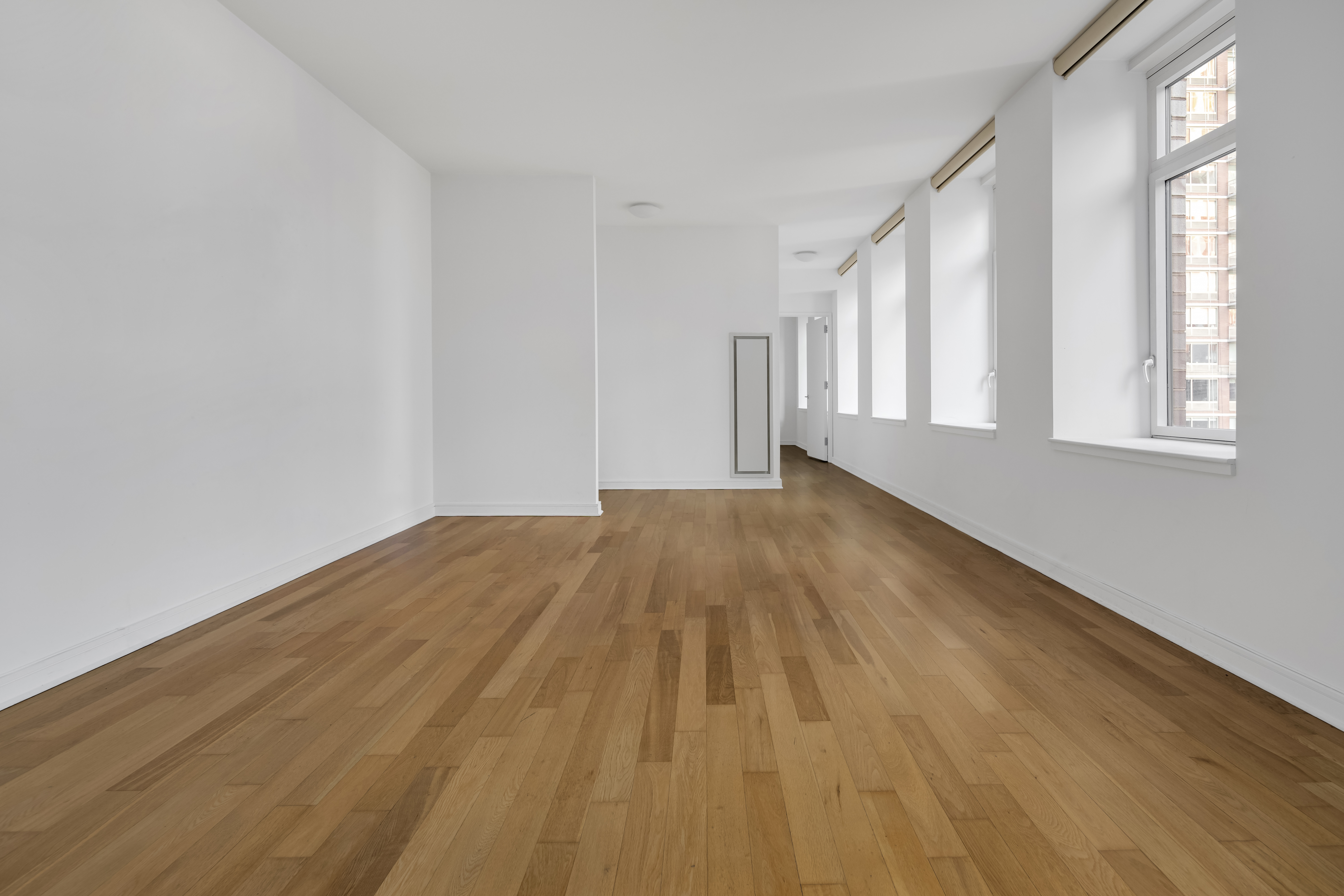 11 East 29th Street, Unit 15B Manhattan, NY 10016 - Photo 2 of 8 a view of empty room with wooden floor and fan
