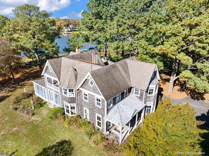 a view of a house with a yard and sitting area