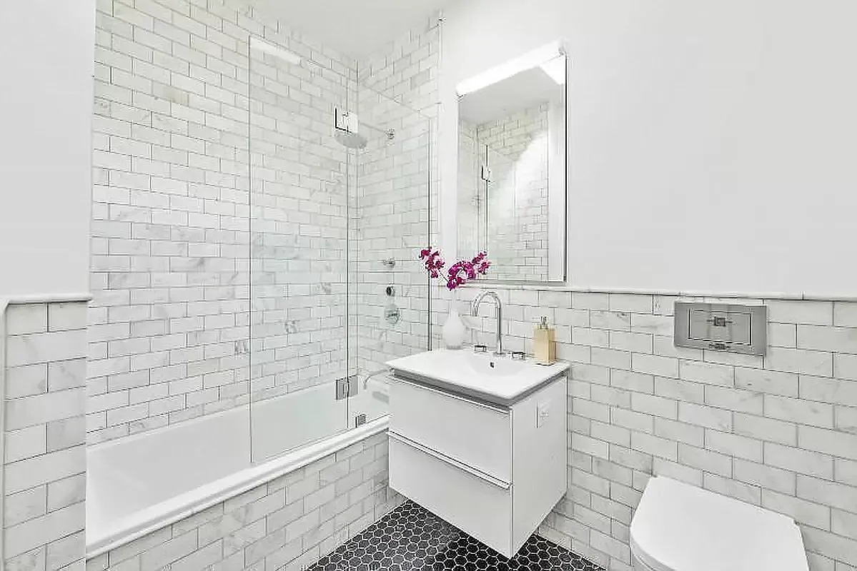 44 East End Avenue, Unit TH1 Manhattan, NY 10028 - Photo 6 of 14 a bathroom with a sink toilet and shower