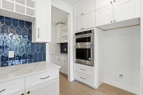 a kitchen with stainless steel appliances a stove microwave and cabinets