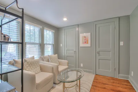 a bedroom with furniture and wooden floor