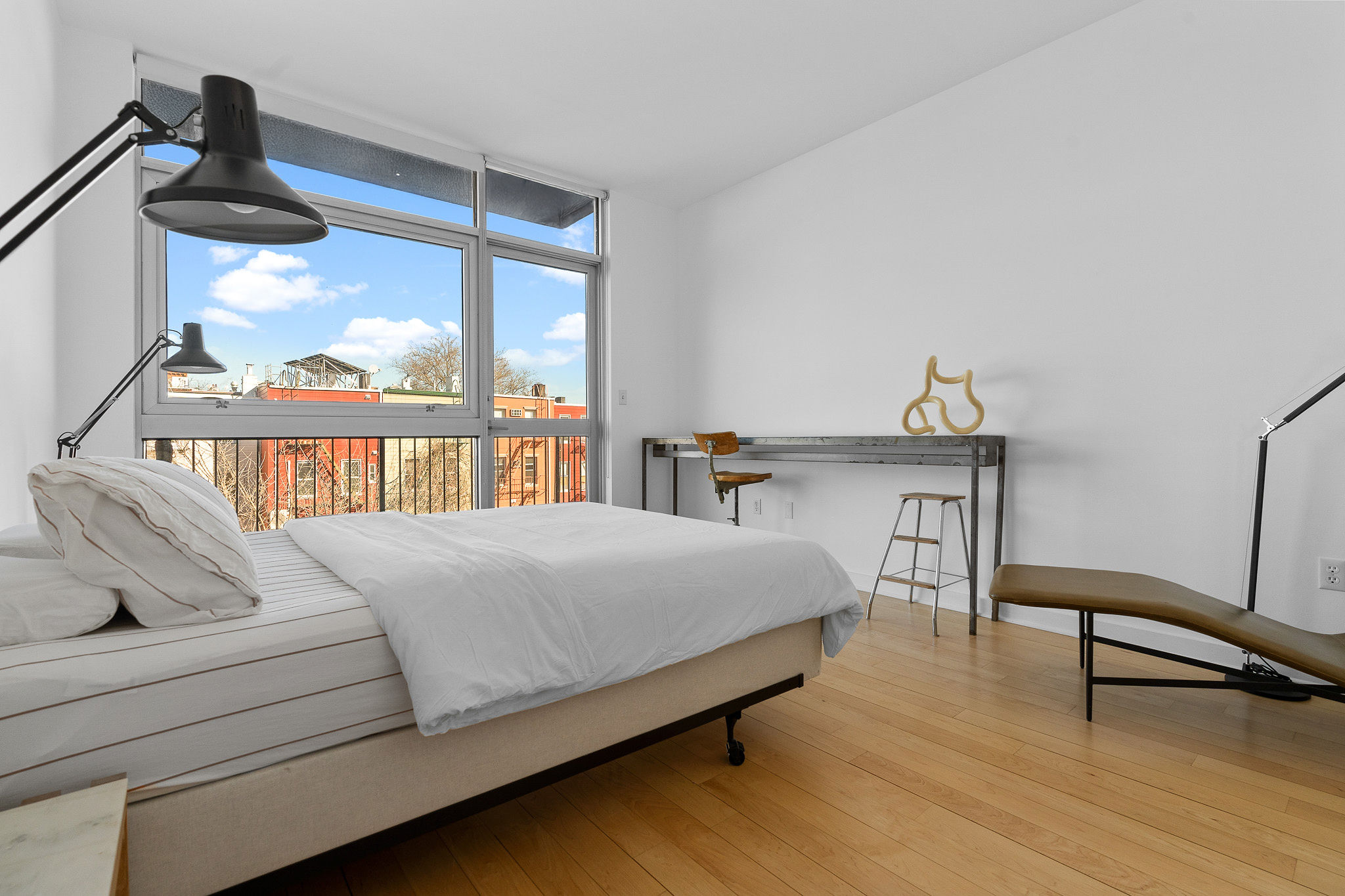 82 Guernsey Street, Unit 3B Brooklyn, NY 11222 - Photo 10 of 18 a bedroom with a bed next to a large window with outer view