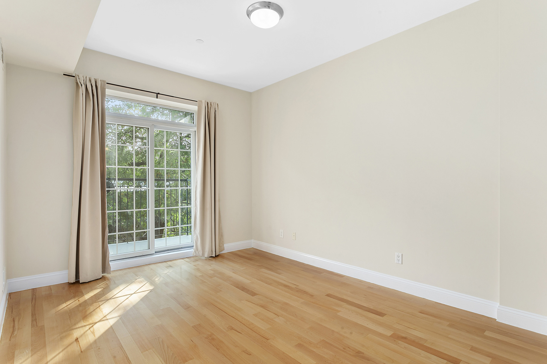 330 Bergen Street, Unit 4D Brooklyn, NY 11217 - Photo 6 of 9 a view of an empty room with wooden floor and a window