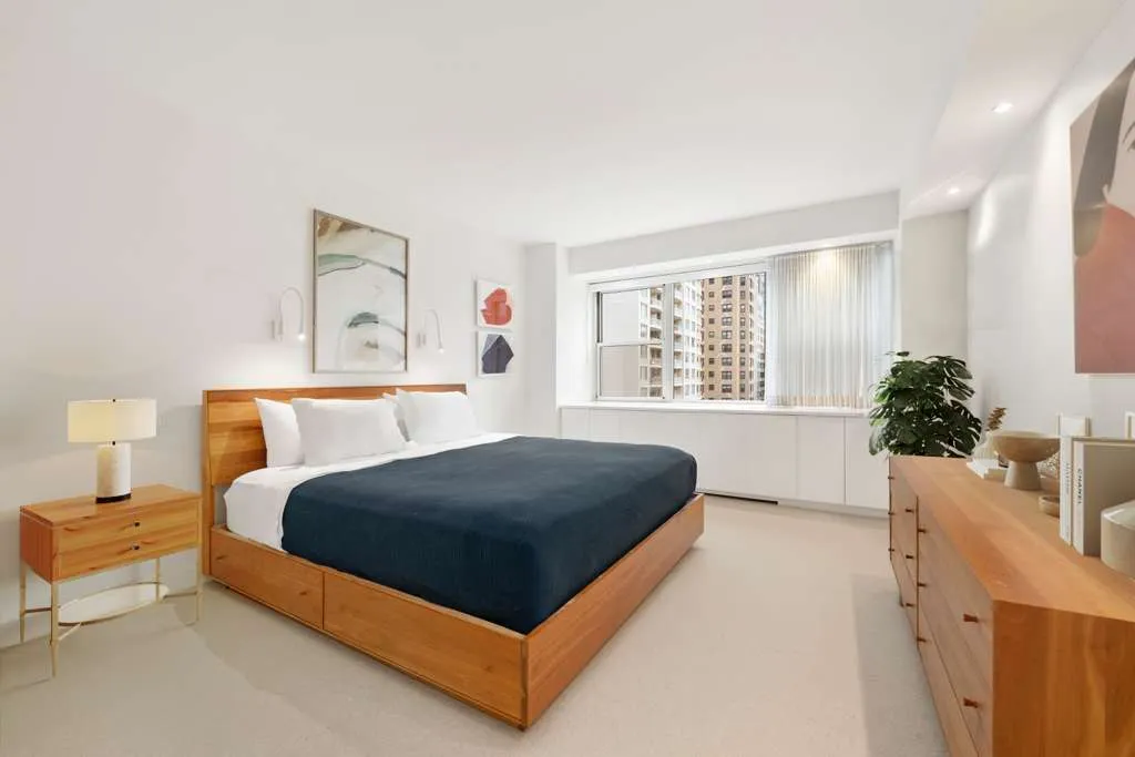 a bedroom with a bed and window