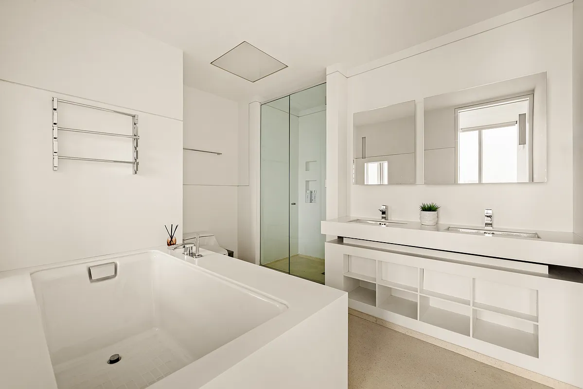 100 11th Avenue, Unit 16A Manhattan, NY 10011 - Photo 5 of 17 a bathroom with a tub sink and mirror