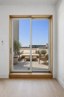 a view of living room with a floor to ceiling window and wooden floor