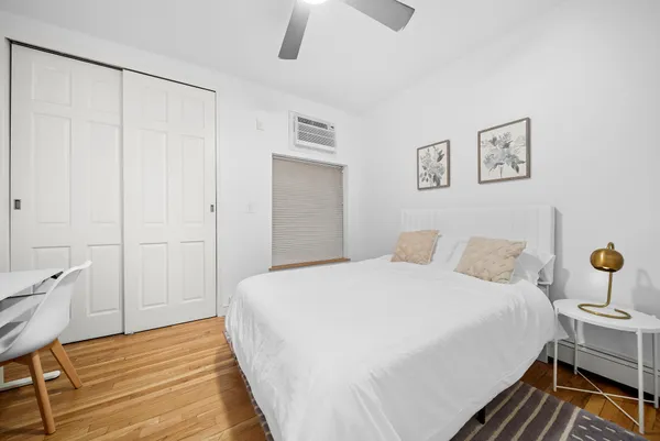 a bedroom with a bed and a table