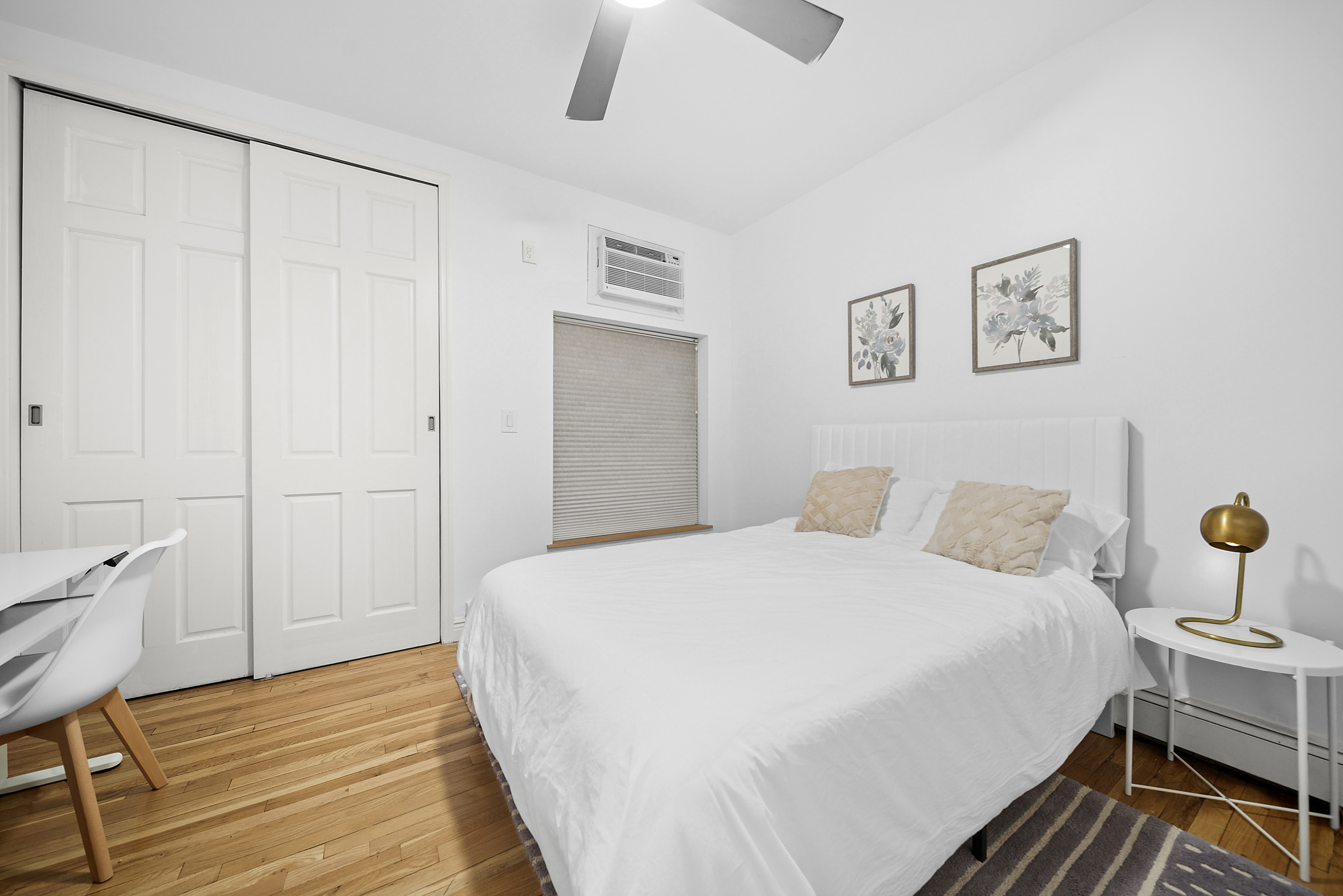 255 West 95th Street, Unit 1B Manhattan, NY 10025 - Photo 4 of 12 a bedroom with a bed and a table