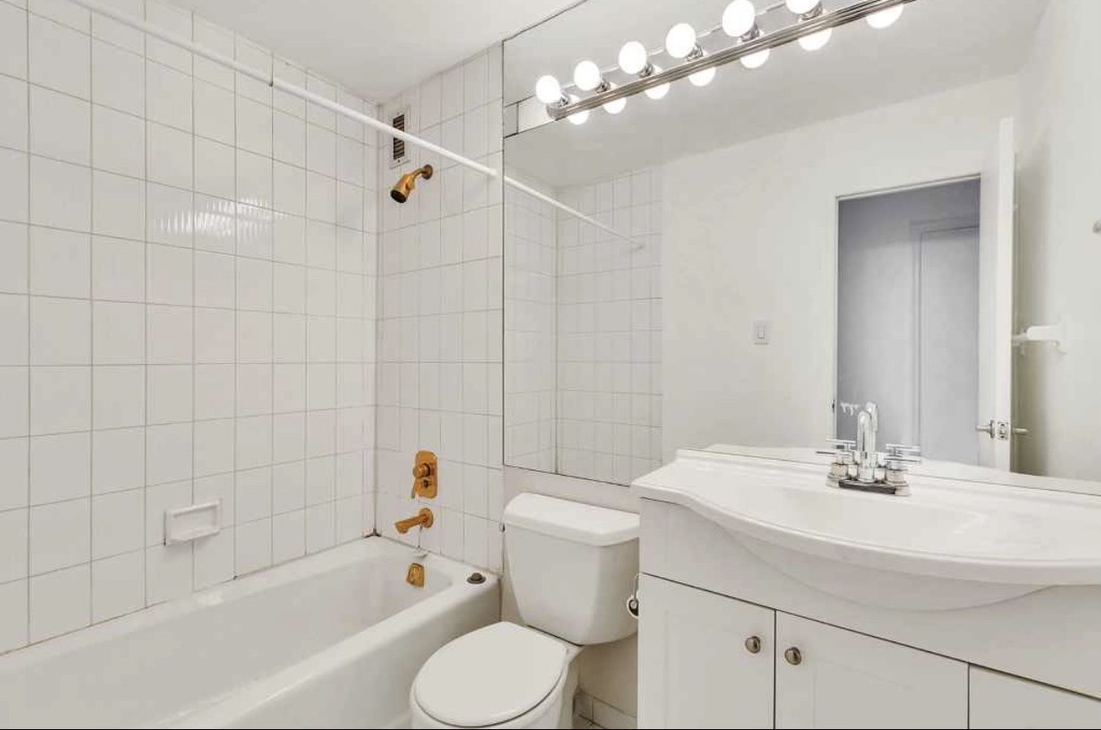 222 West 14th Street, Unit 5D Manhattan, NY 10011 - Photo 5 of 9 a bathroom with a sink a toilet and shower