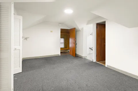 an empty room with closet and wooden door