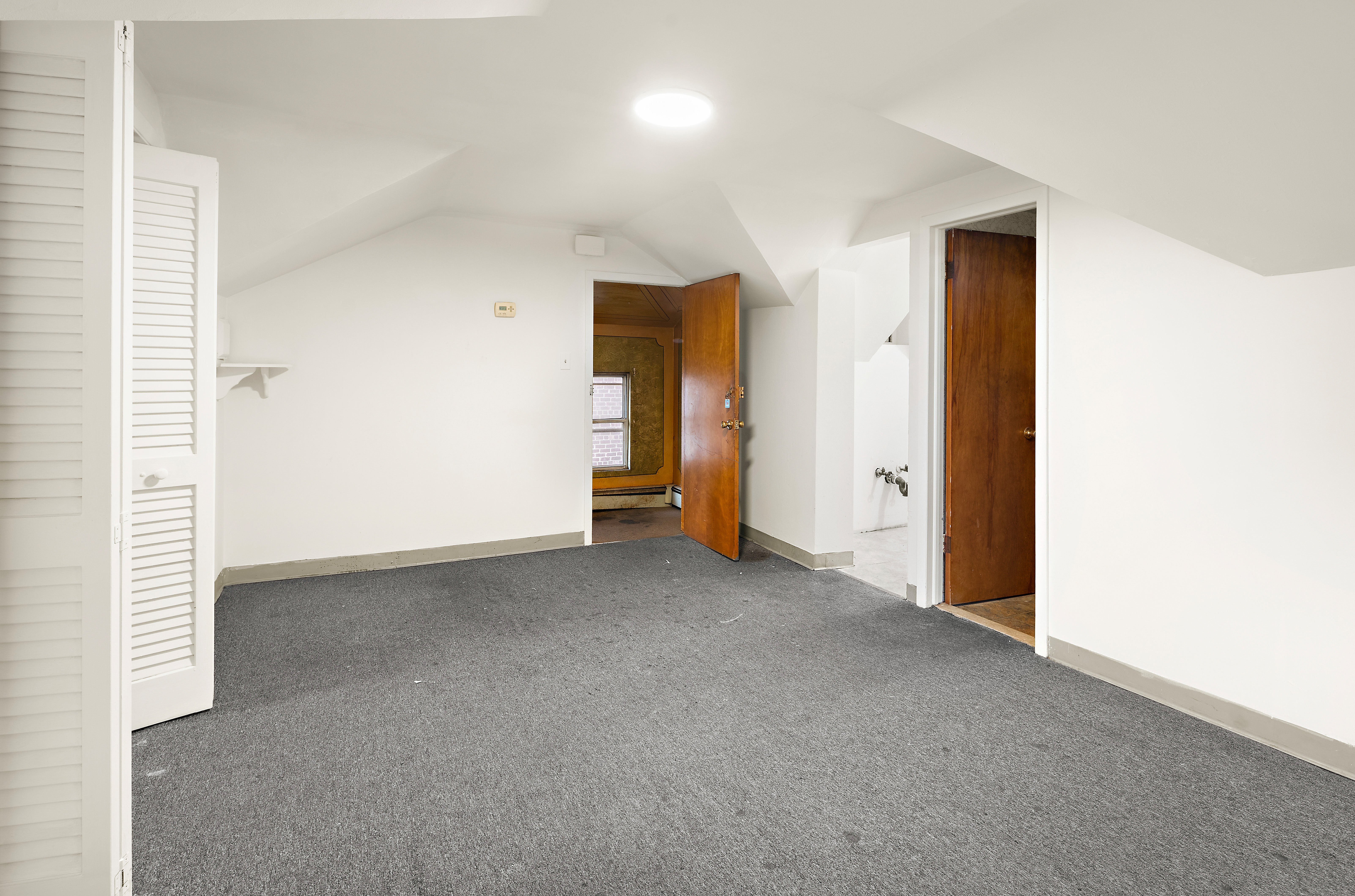 562 84th Street Brooklyn, NY 11209 - Photo 19 of 25 an empty room with closet and wooden door