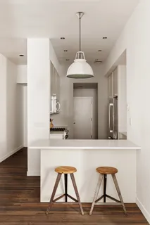 a view of hall way with furniture and wooden floor