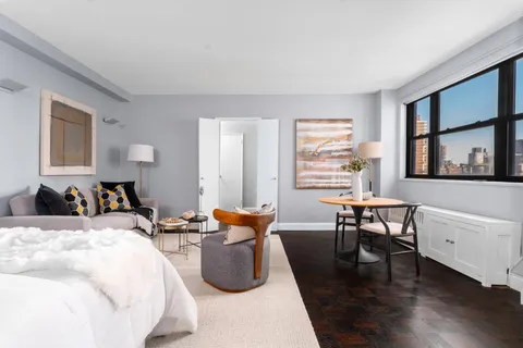 a bed room with furniture and a window