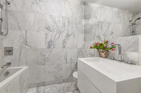 a bathroom with a sink a vanity and a tub