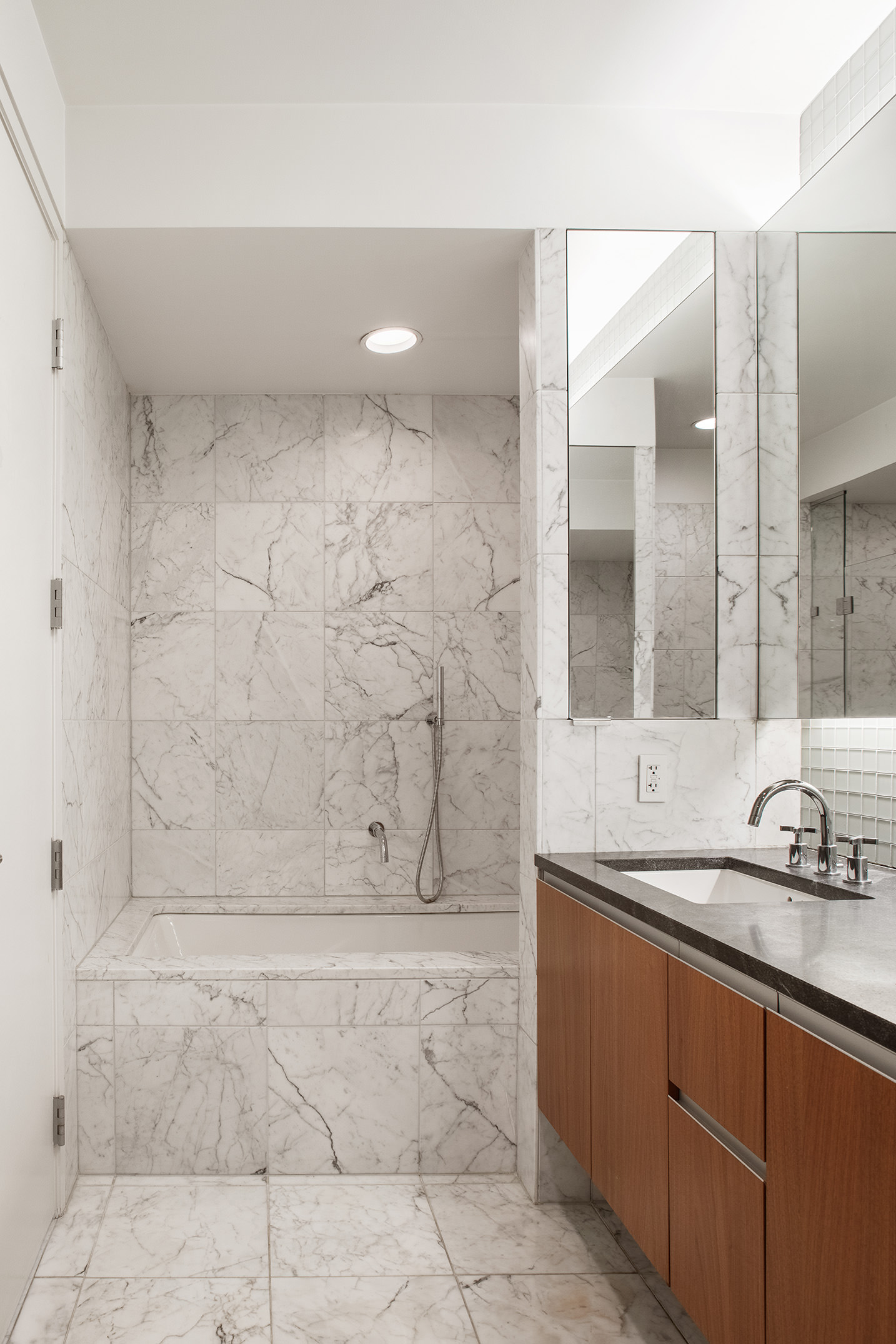 311 West Broadway, Unit 6J Manhattan, NY 10013 - Photo 10 of 19 a bathroom with a granite countertop sink a mirror and shower
