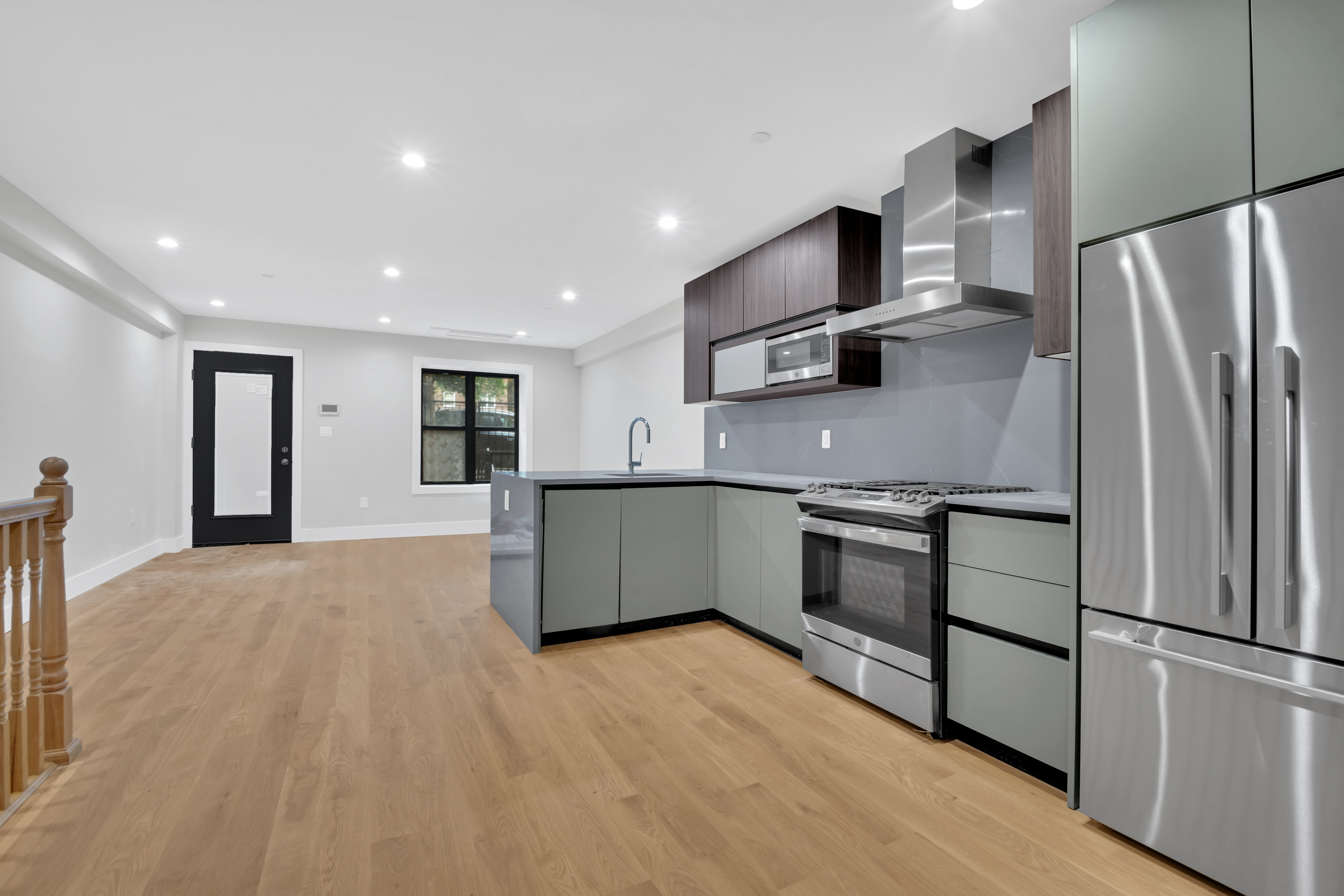 265 West 131st Street, Unit GARDEN Manhattan, NY 10027 - Photo 4 of 11 a kitchen with stainless steel appliances granite countertop a refrigerator a stove and a sink