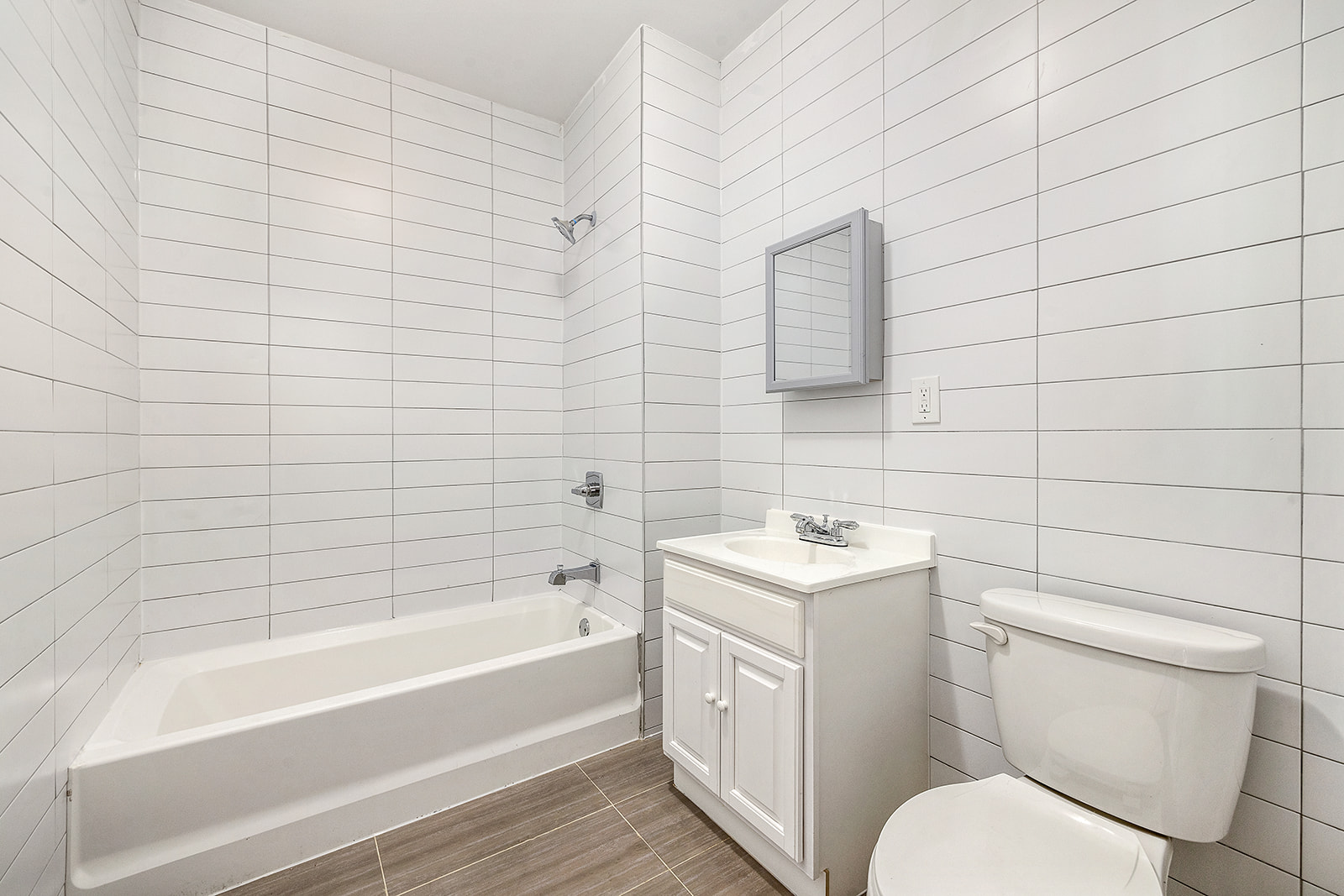 422 East 31st Street Brooklyn, NY 11226 - Photo 6 of 16 a bathroom with a sink toilet vanity and bathtub