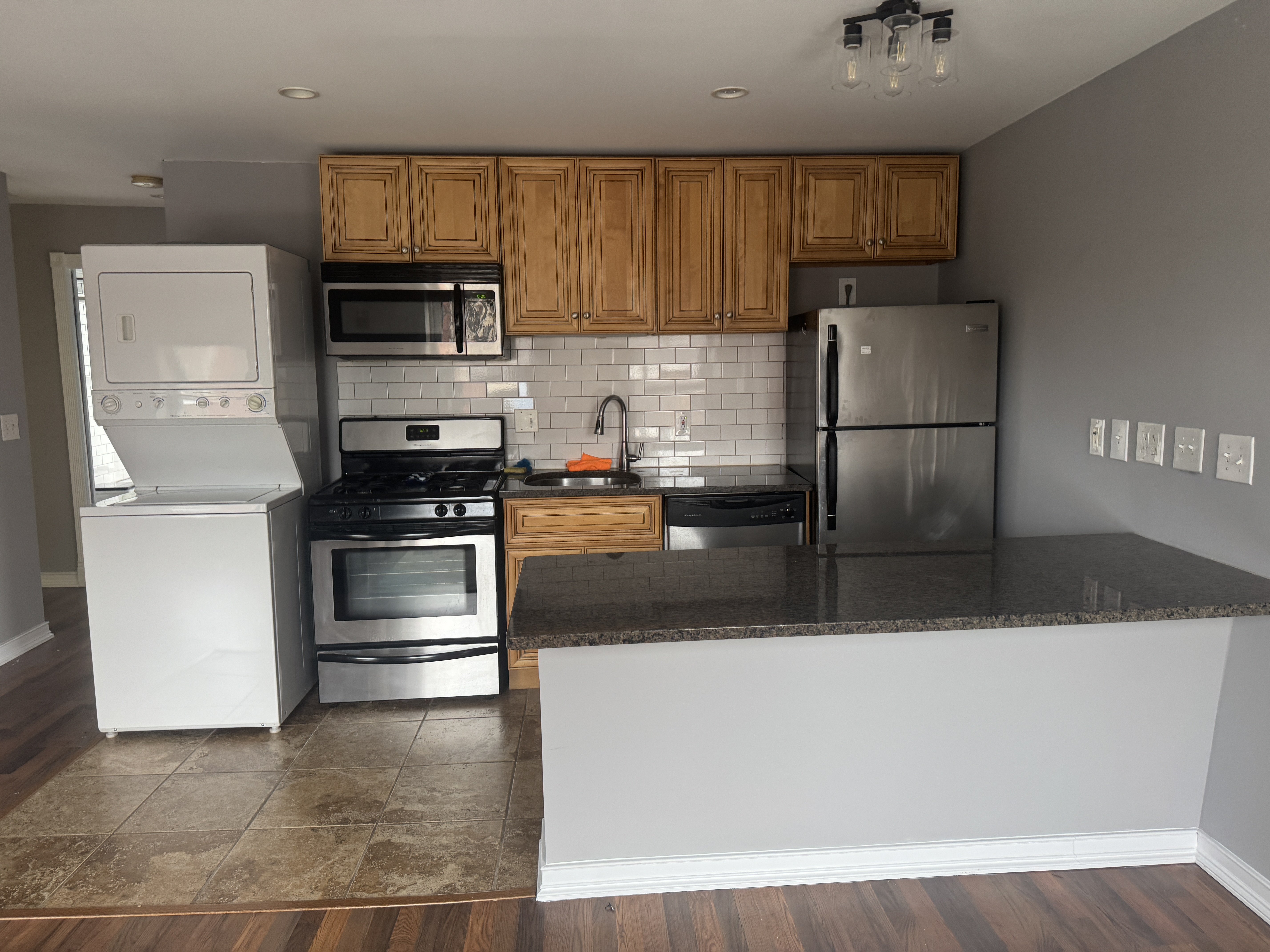 193 24th Street, Unit 2 Brooklyn, NY 11232 - Photo 3 of 7 a kitchen with stainless steel appliances a refrigerator and a stove top oven