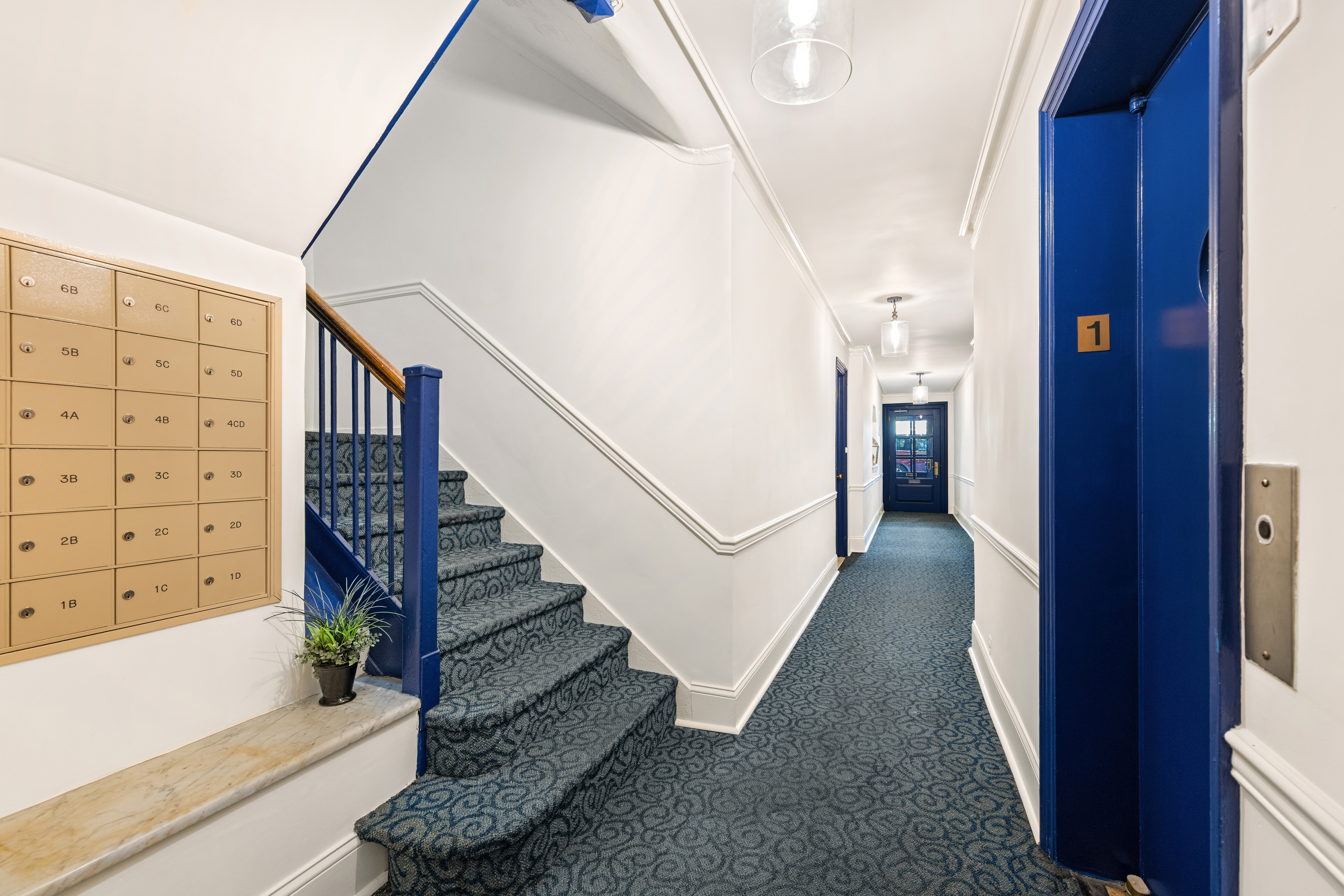 436 East 58th Street, Unit 1C Manhattan, NY 10022 - Photo 10 of 14 a view of staircase with white walls and a window