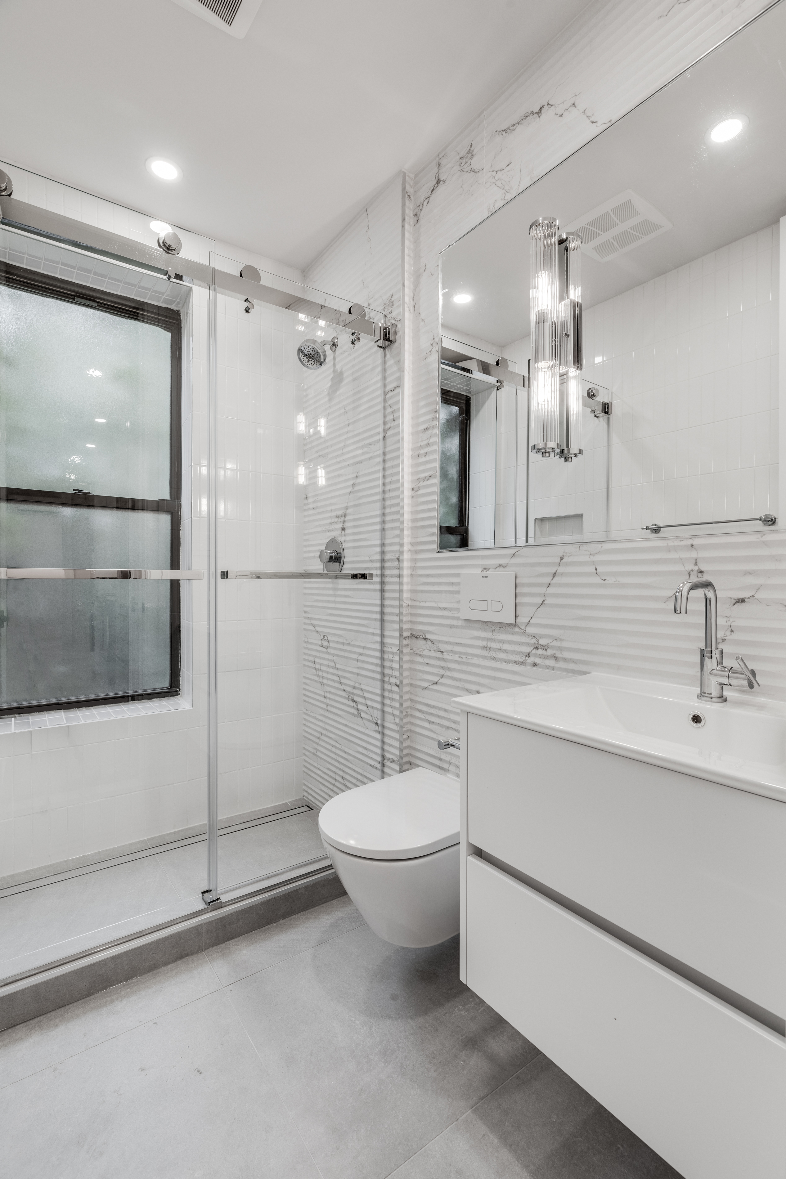 14 Bedford Street, Unit 19 Manhattan, NY 10014 - Photo 4 of 5 a bathroom with a double vanity sink toilet and shower