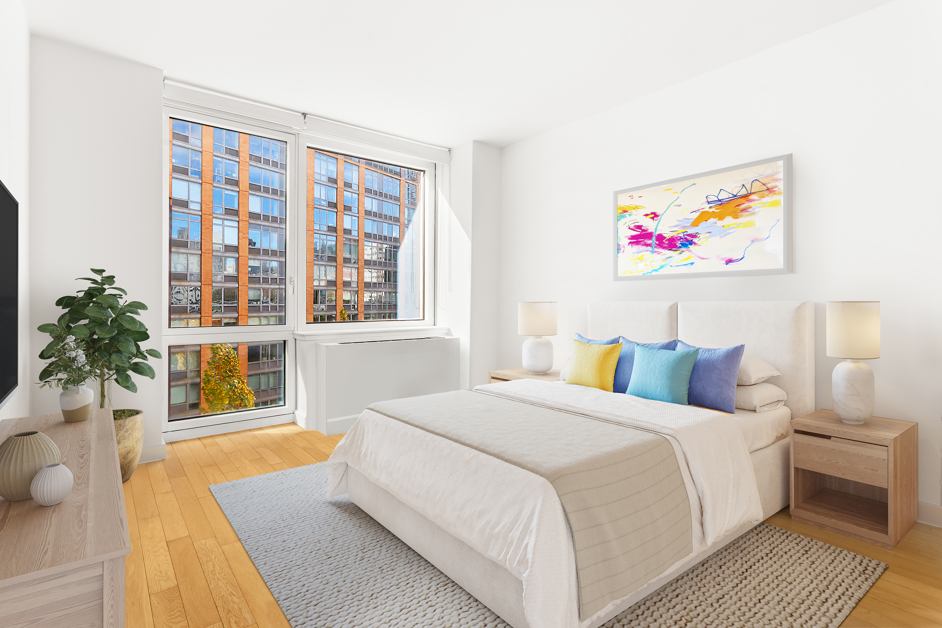 415 Main Street, Unit 7C Manhattan, NY 10044 - Photo 9 of 16 a bedroom with a bed and a painting on the wall