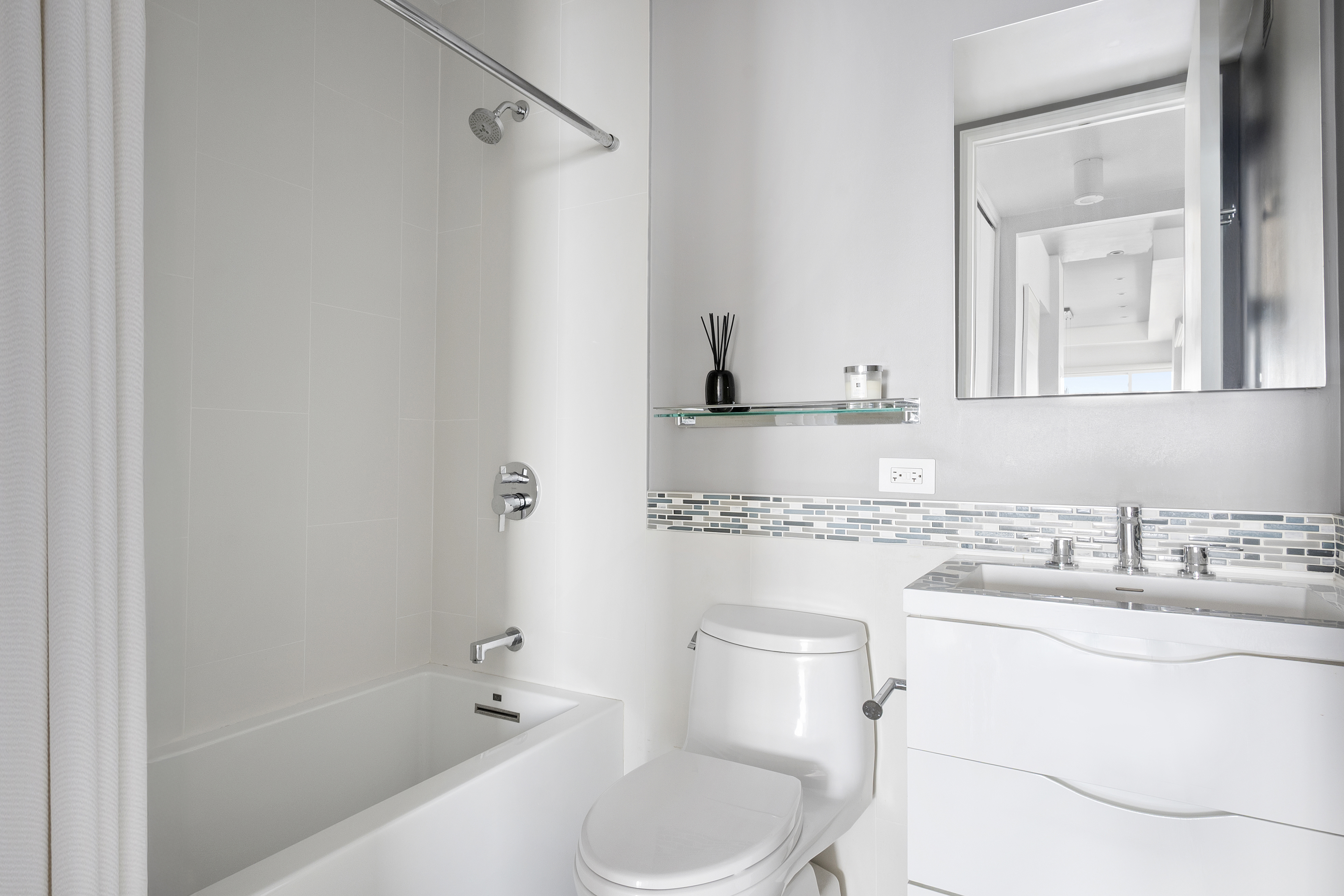 350 West 50th Street, Unit PH4B Manhattan, NY 10019 - Photo 10 of 18 a bathroom with a sink toilet vanity and shower