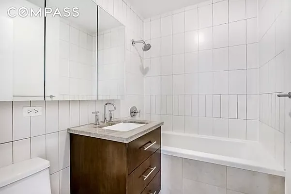 125 North 5th Street, Unit 2E Brooklyn, NY 11249 - Photo 7 of 11 a bathroom with a sink and a mirror