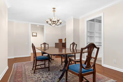 a view of a dining room with furniture wooden floor and a chandelier