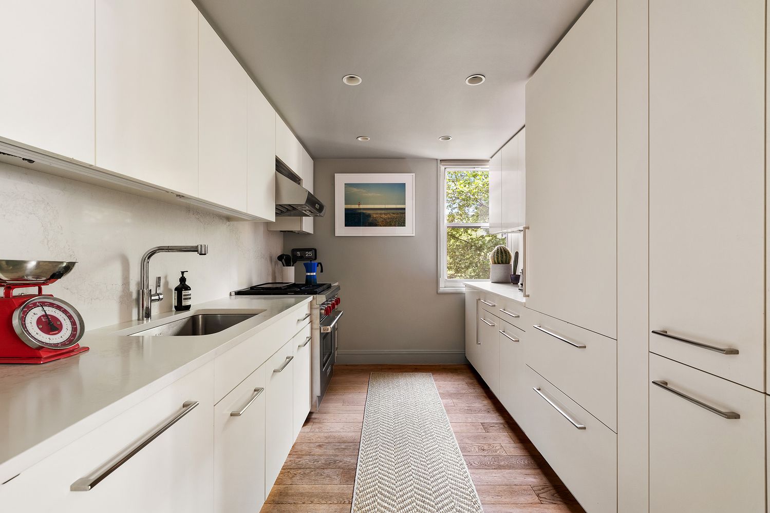 a kitchen with granite countertop a sink and cabinets