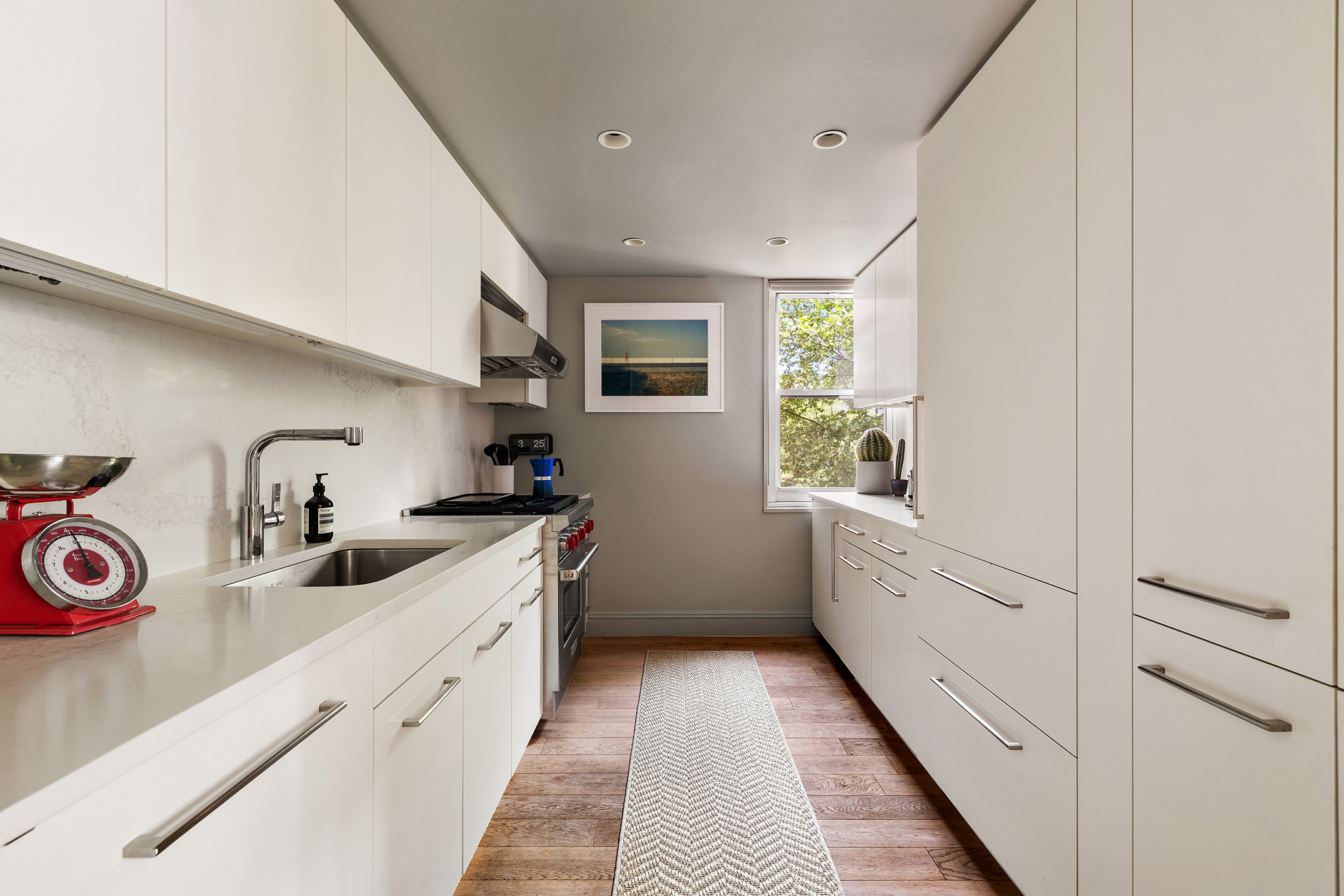 360 West 22nd Street, Unit 5M Manhattan, NY 10011 - Photo 5 of 16 a kitchen with granite countertop a sink and cabinets