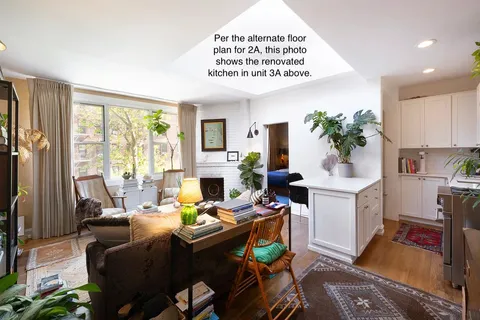 a living room with furniture fireplace and a large window