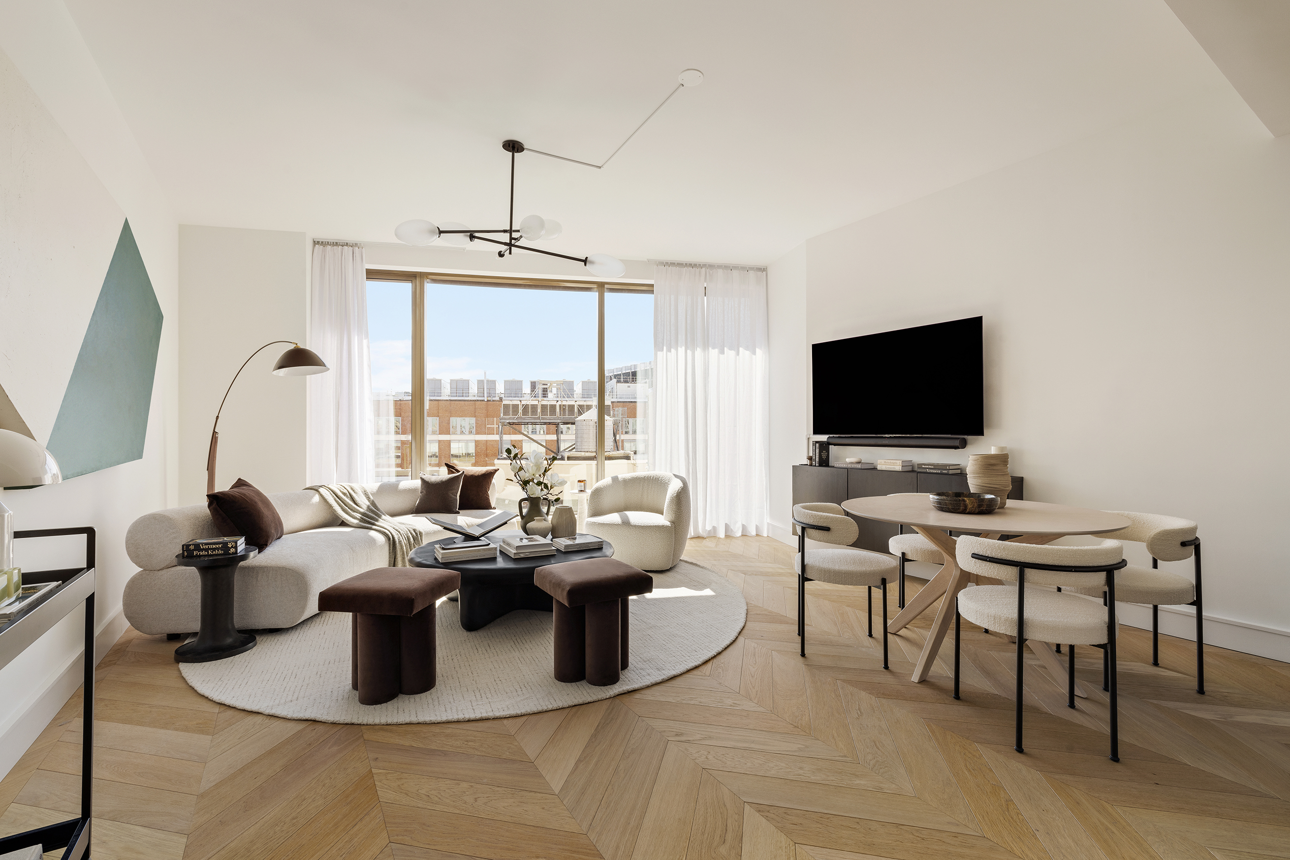 500 West 18th Street, Unit EAST 15G Manhattan, NY 10011 - Photo 2 of 26 a living room with fireplace furniture and a flat screen tv