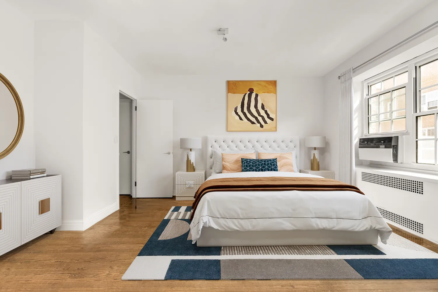 a bedroom with a bed and a large window