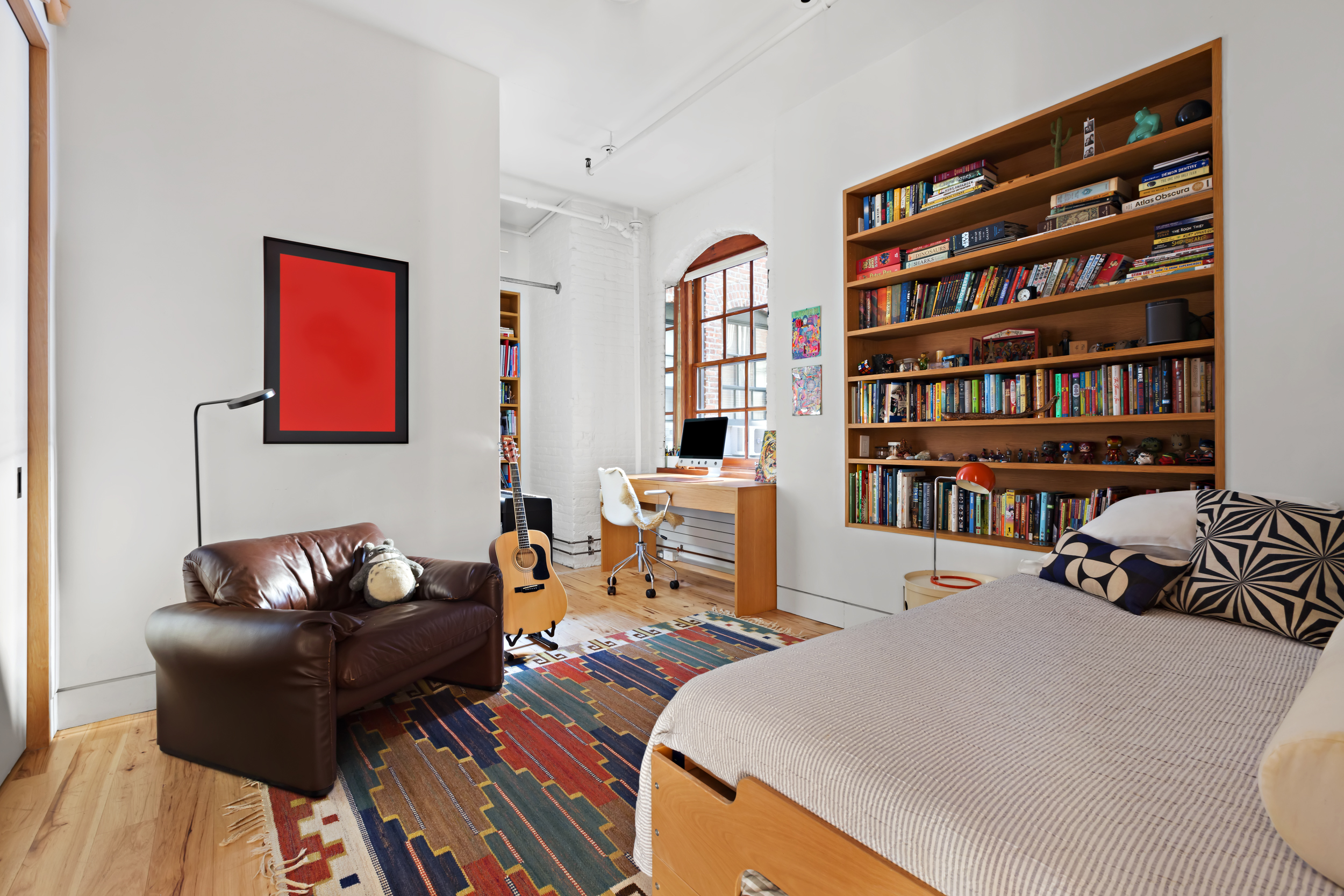 463 Greenwich Street Manhattan, NY 10013 - Photo 13 of 24 a bedroom with a bed and a book shelf