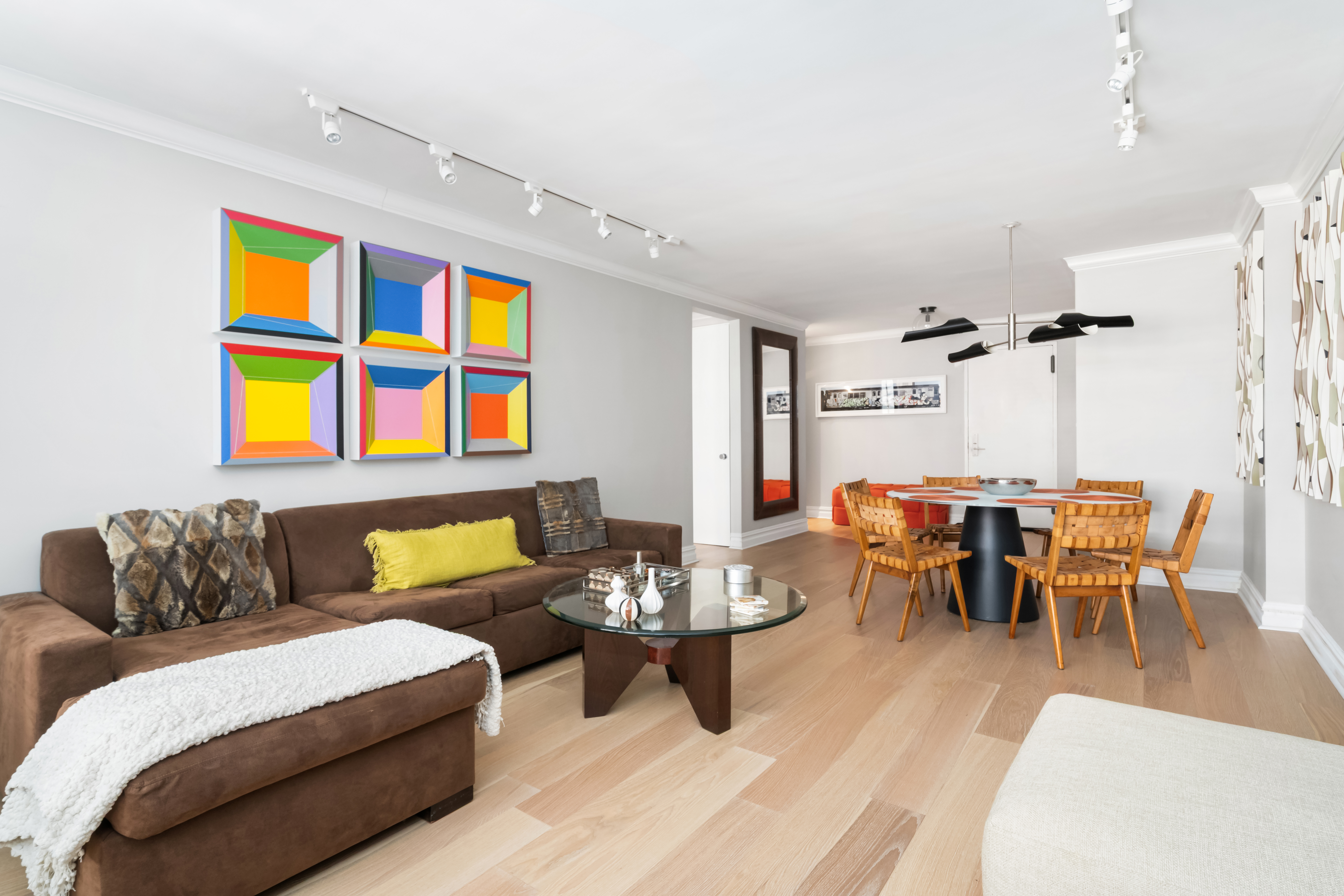 77 West 55th Street, Unit 9F Manhattan, NY 10019 - Photo 5 of 11 a living room with furniture wooden floor and dining table