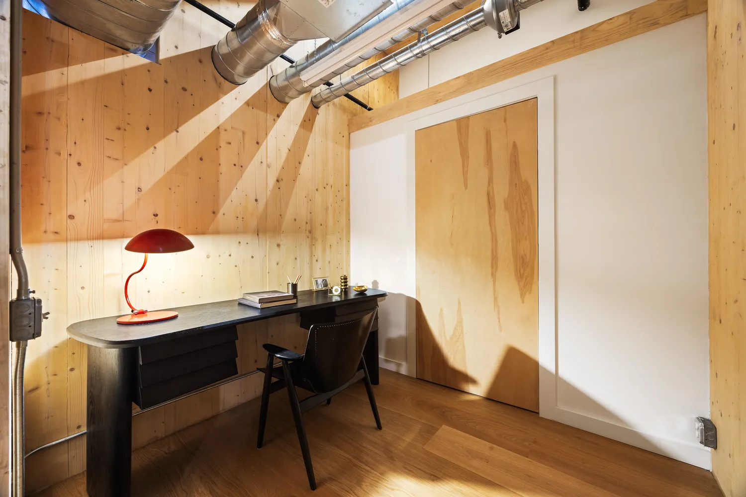 a view of a hallway with wooden floor and stairs