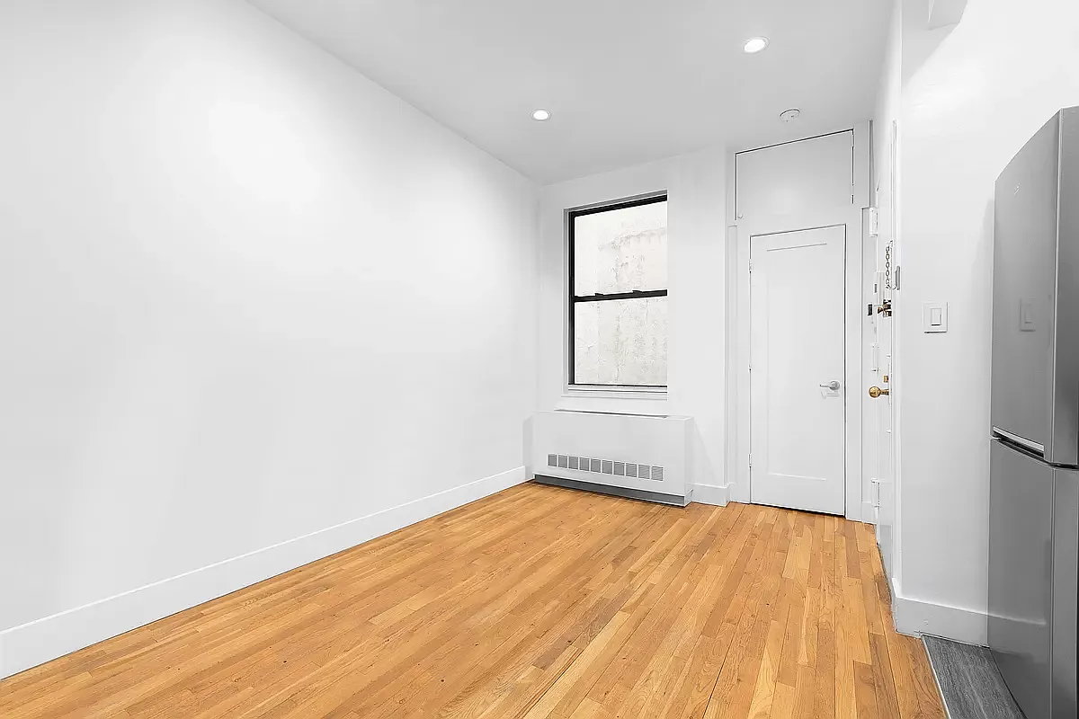 1582 York Avenue, Unit 2C Manhattan, NY 10028 - Photo 4 of 12 a view of empty room with wooden floor