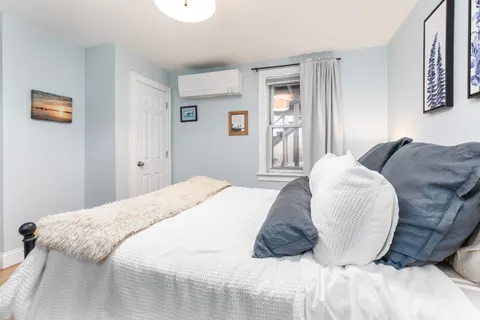 a bedroom with a bed and a couch