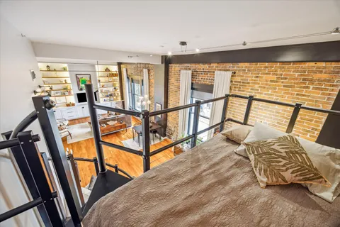 a bedroom with furniture and a large window