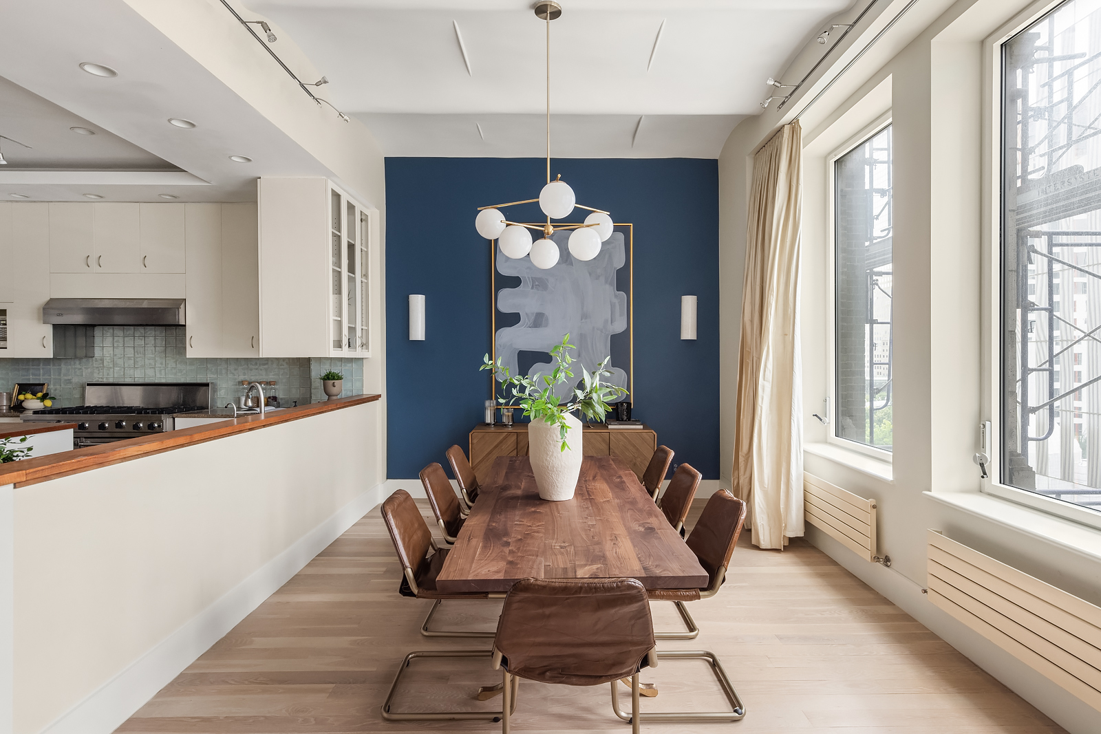114 Liberty Street, Unit 7 Manhattan, NY 10006 - Photo 4 of 15 a dining room with furniture potted plants and wooden floor