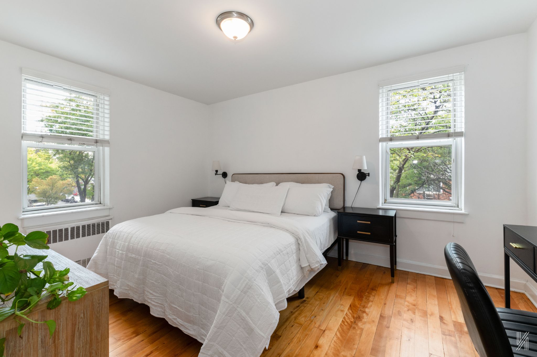 39-55 51st Street, Unit 3G Queens, NY 11377 - Photo 11 of 18 a bed sitting in a bedroom next to a window