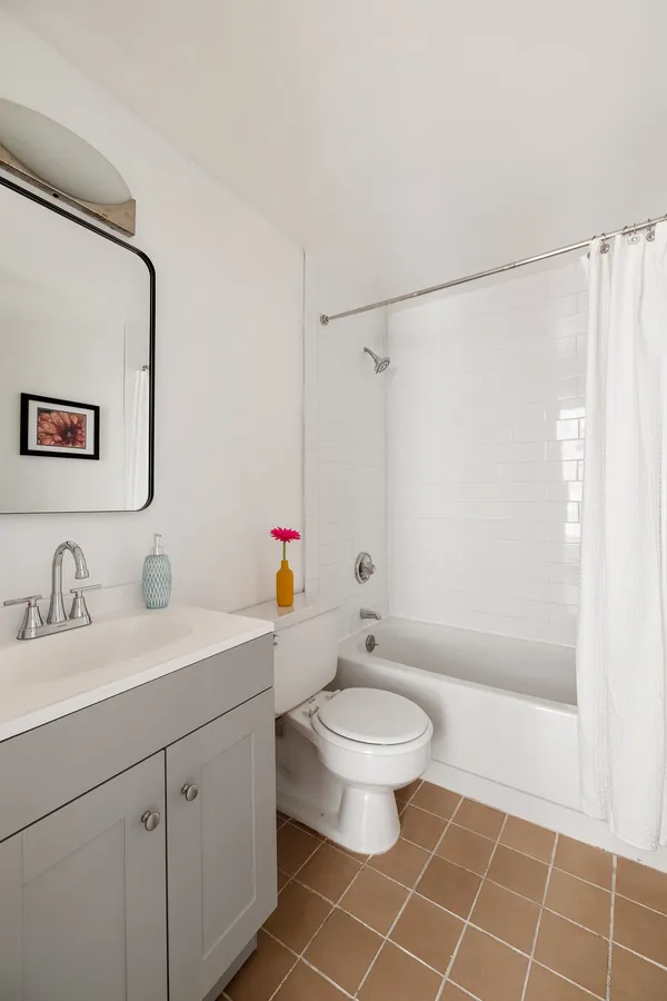 a bathroom with a granite countertop sink a toilet and a mirror