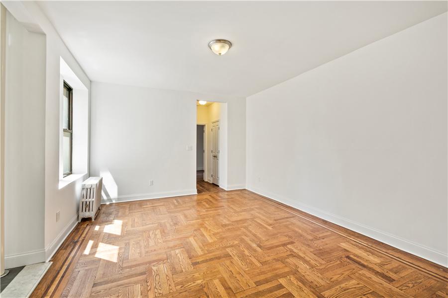 61-09 39th Avenue, Unit 2H Queens, NY 11377 - Photo 4 of 9 a view of empty room with window