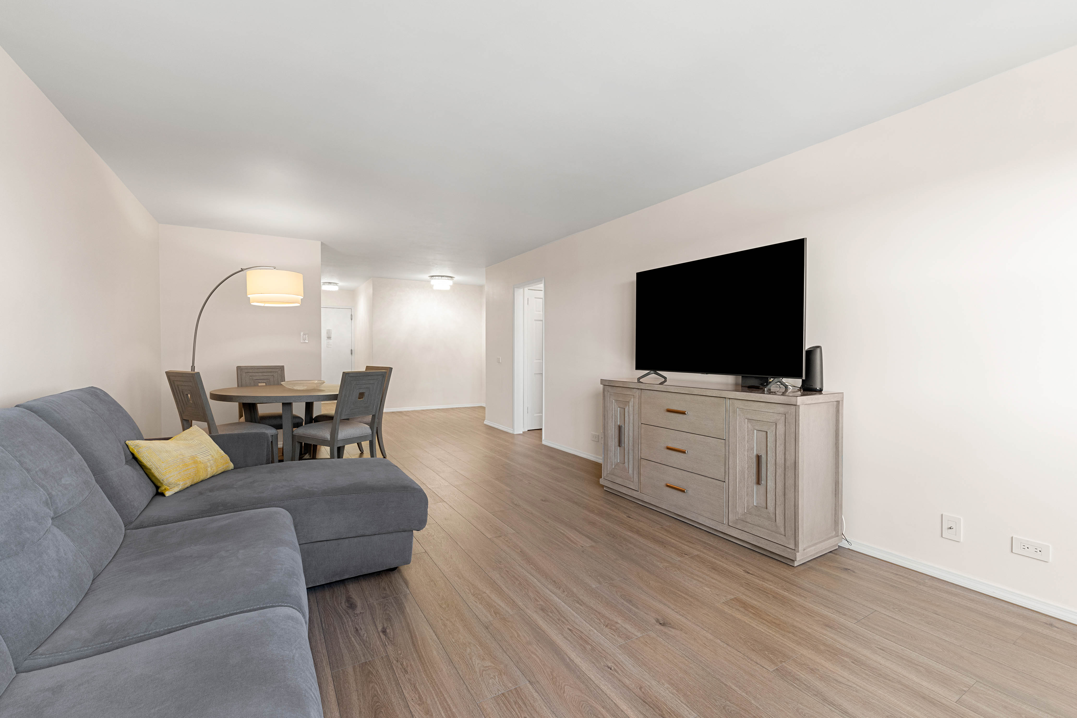 102-10 66th Road, Unit 21K Queens, NY 11375 - Photo 3 of 16 a living room with furniture and a flat screen tv