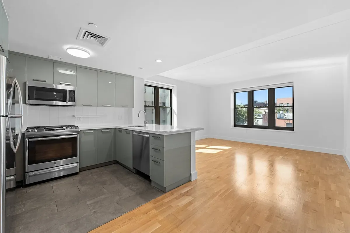 a kitchen with stainless steel appliances granite countertop a stove and a sink
