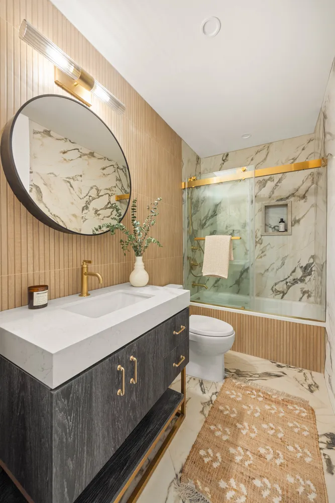 a bathroom with a sink mirror vanity and toilet