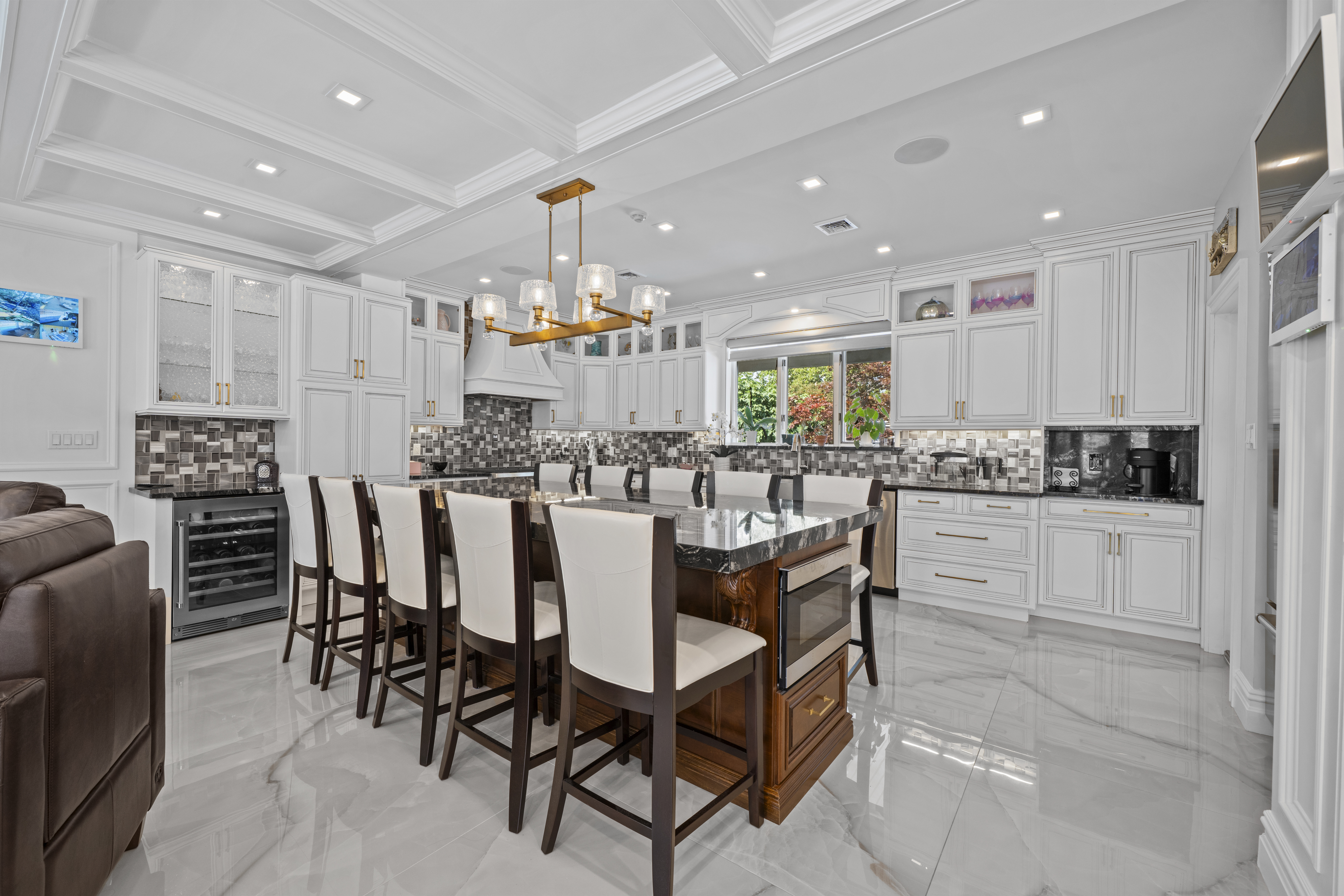 2253 East 64th Street Brooklyn, NY 11234 - Photo 7 of 45 a kitchen with stainless steel appliances kitchen island granite countertop a table and chairs