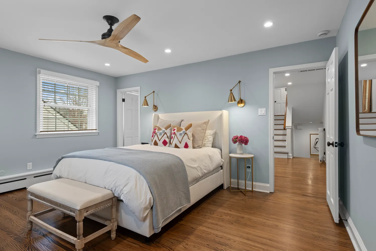a bathroom with a tub sink and a mirror