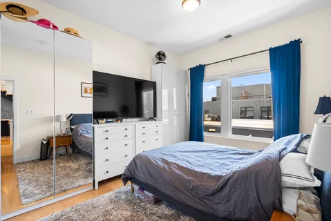 a bedroom with a bed and flat screen tv